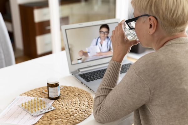 close-up-senior-woman-talking-online-doctor